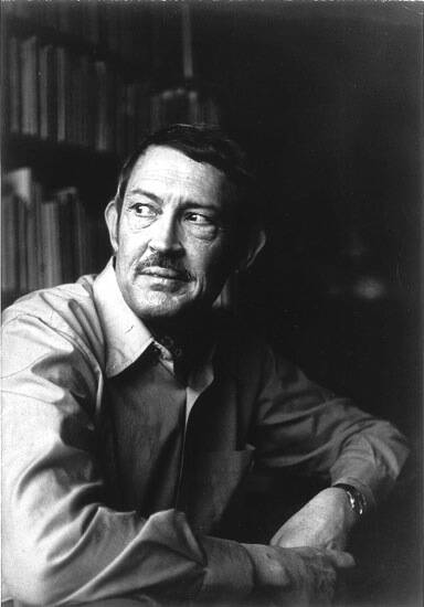 Photograph of a man seated and looking to the left